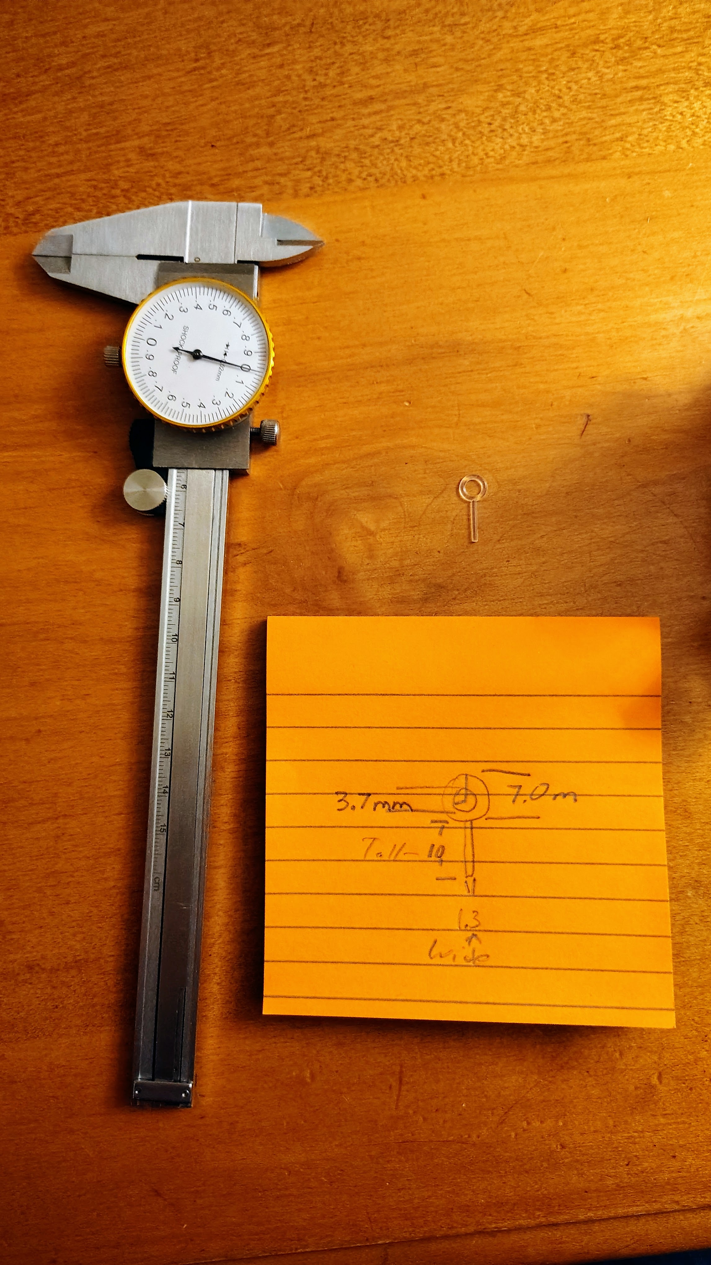 Measuring the tiny hook with calipers and recording measurements
